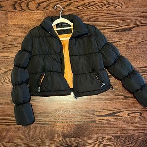 Black cropped puffer jacket.